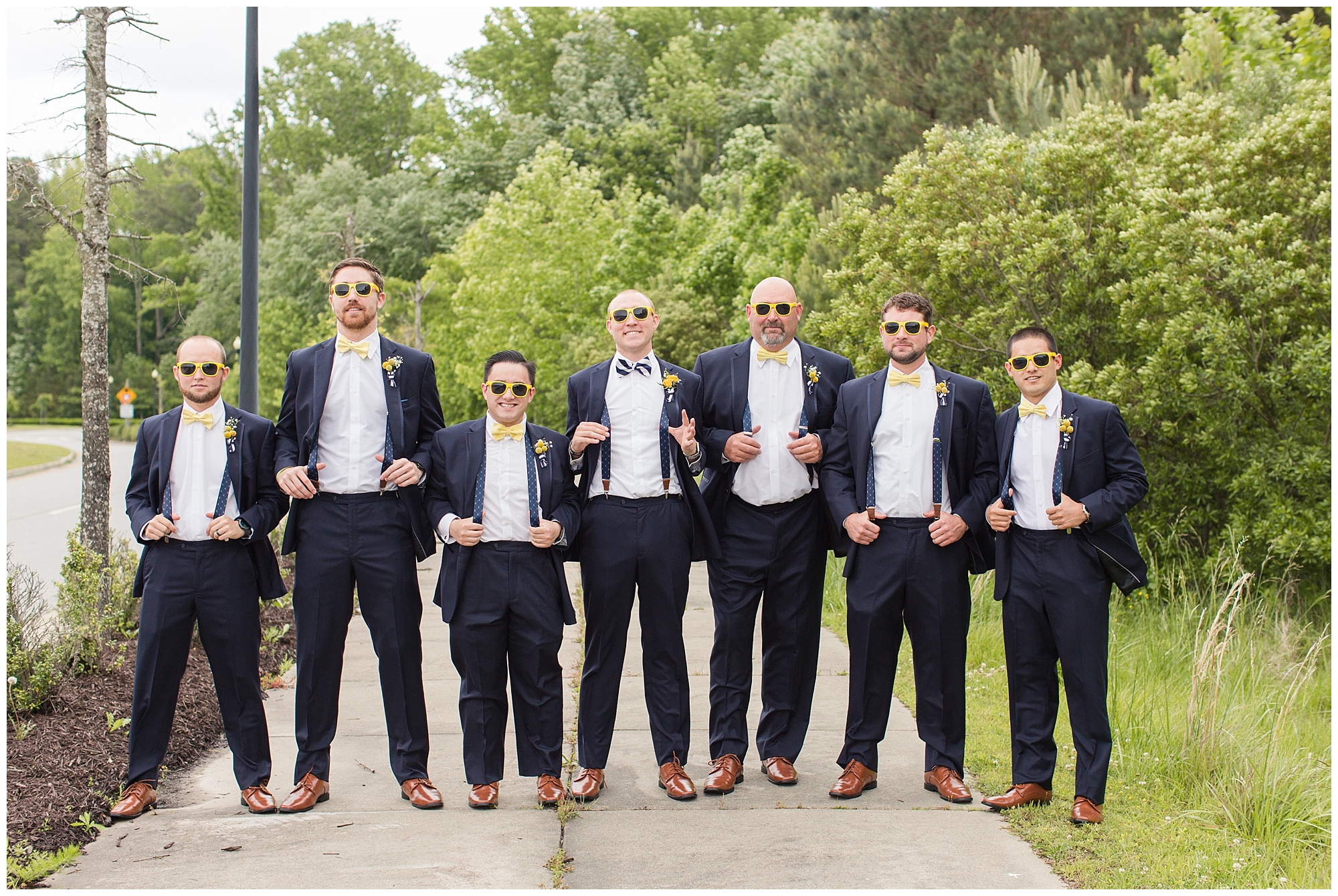 groomsmen wearing yellow sunglasses and suspenders