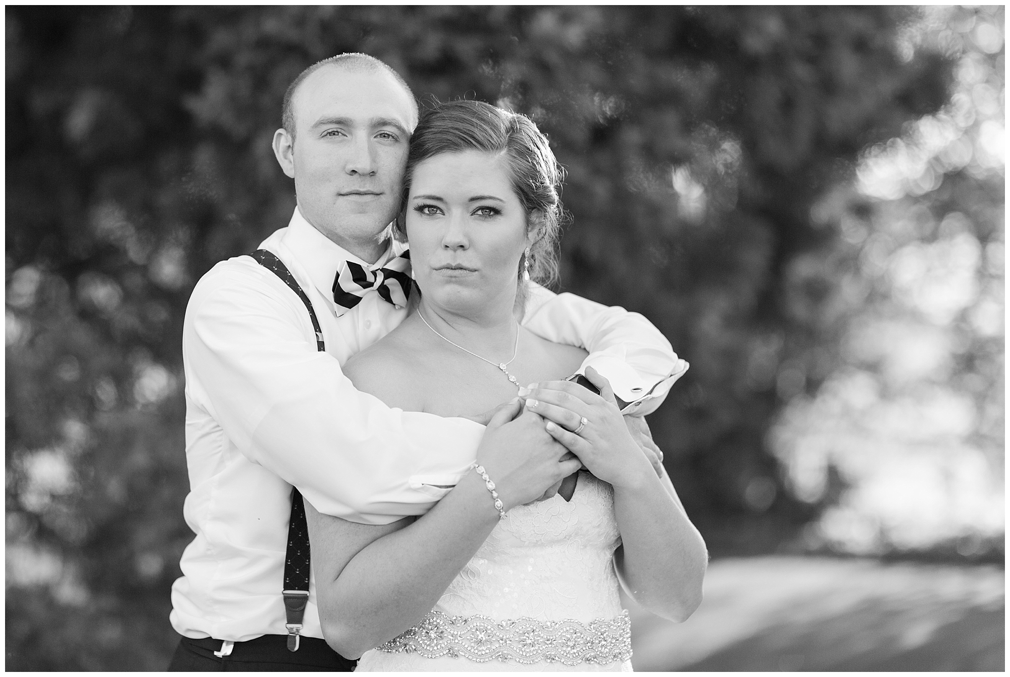 bride and groom no smiles black and white portrait