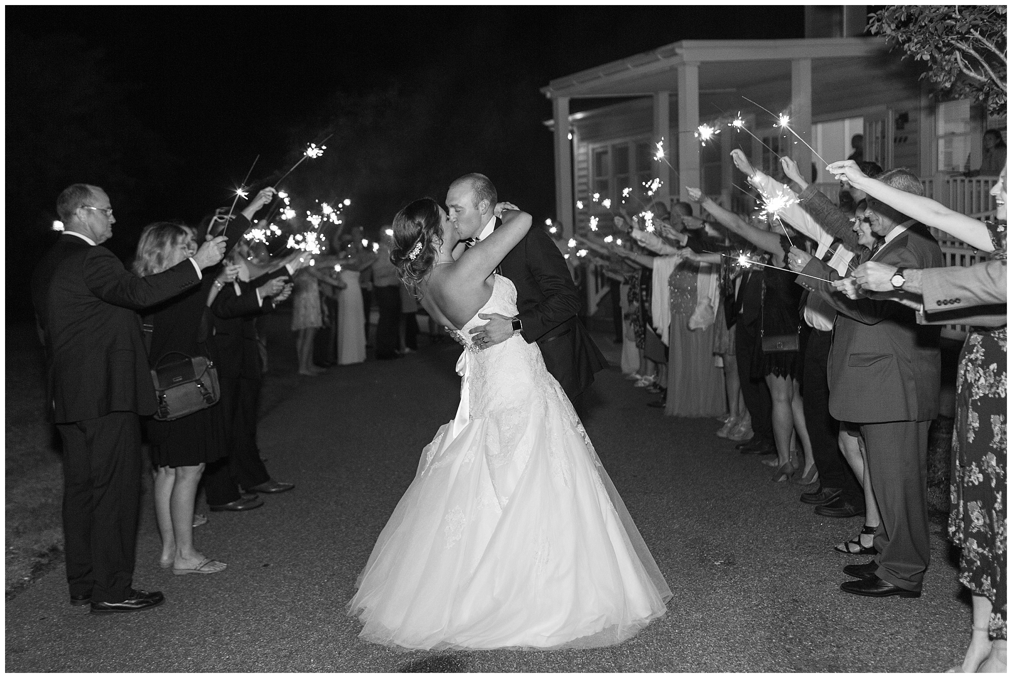 bride and groom kissing during sparkler send off