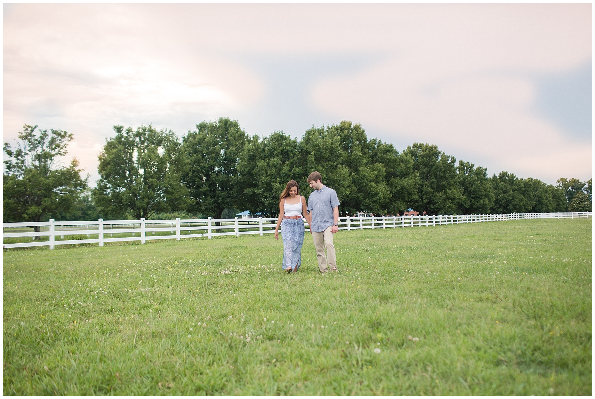 couple walking in pasture at back bay farms