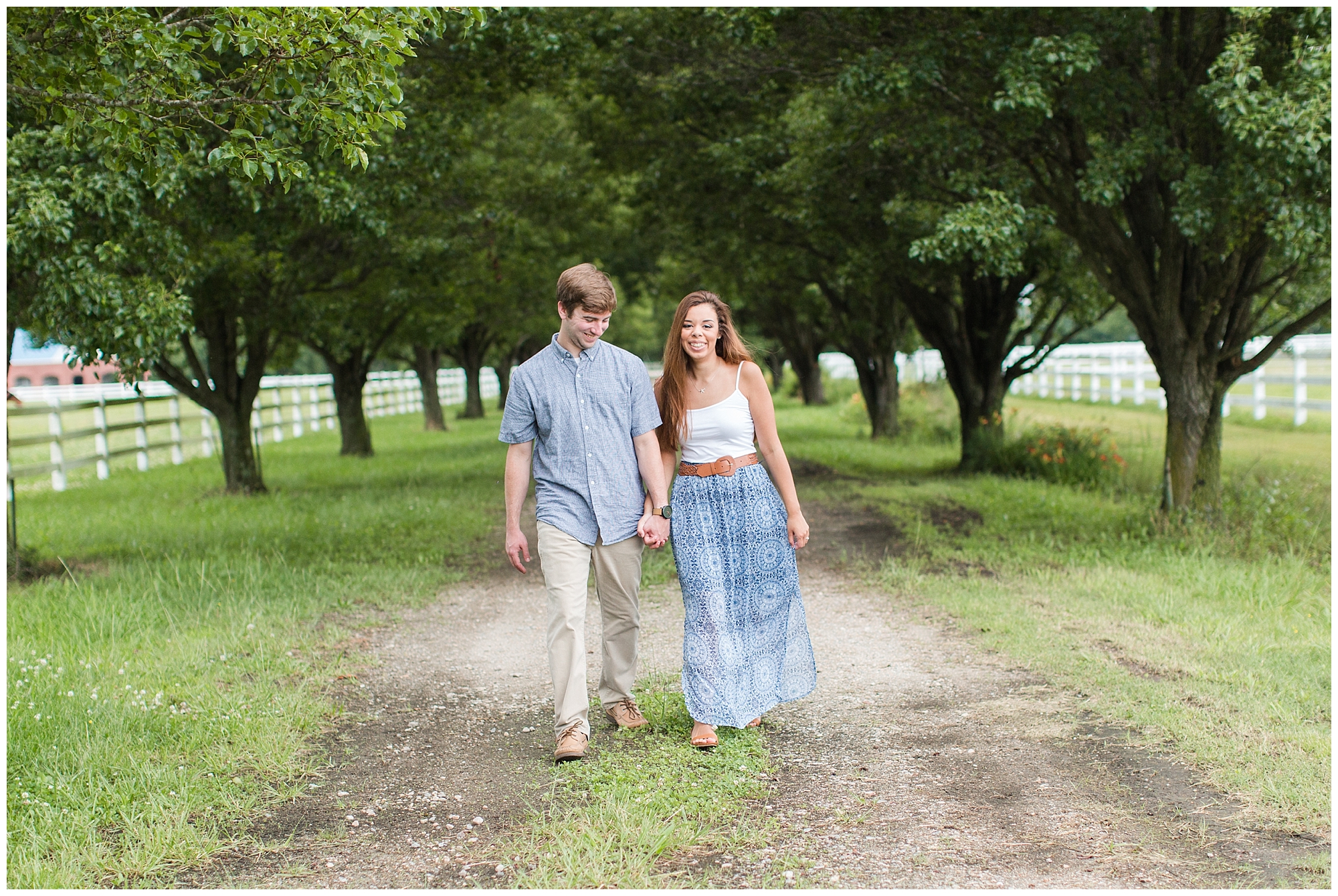 couple walking between the trees at back bay farms