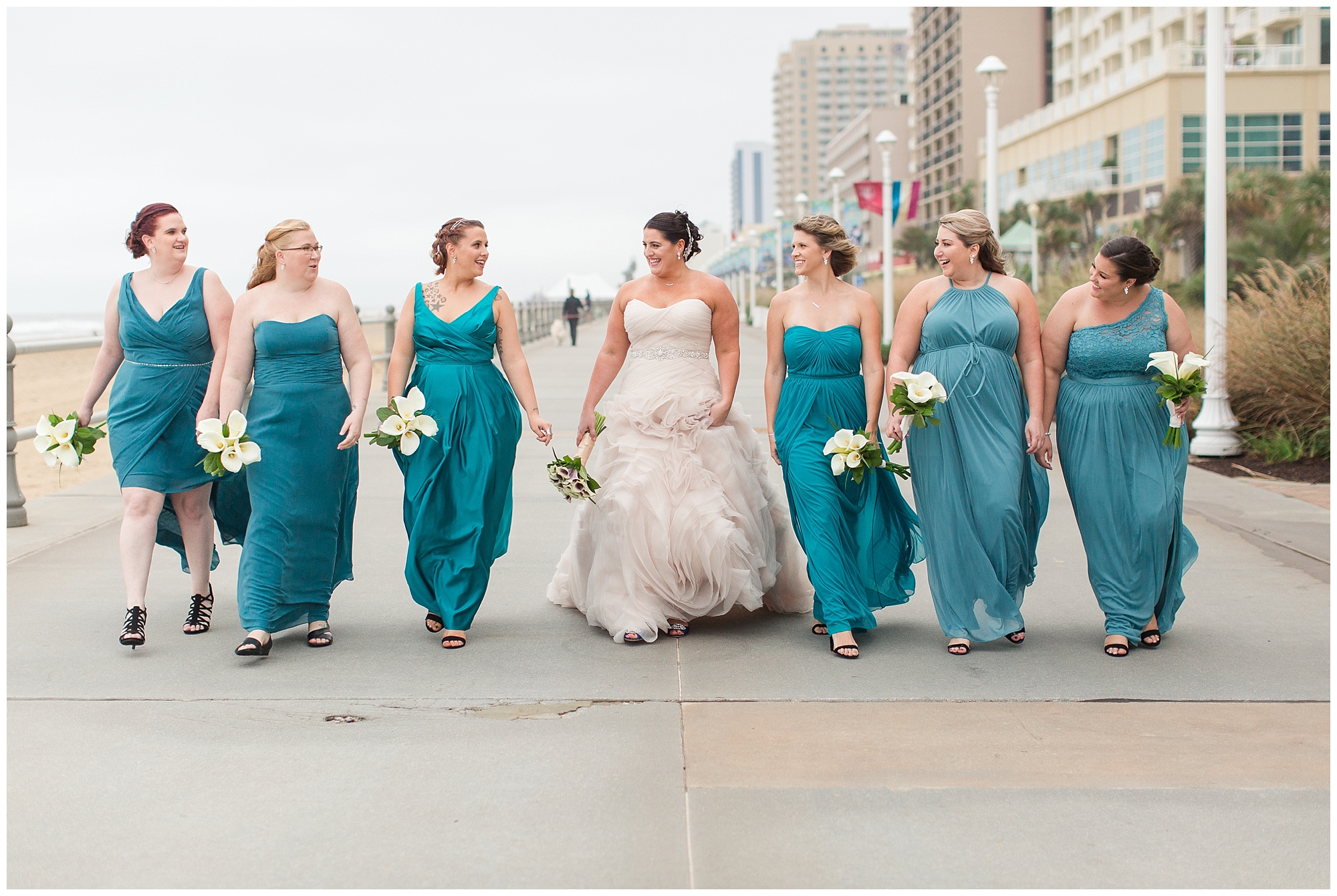bride and bridesmaids walking on Virginia Beach boardwalk
