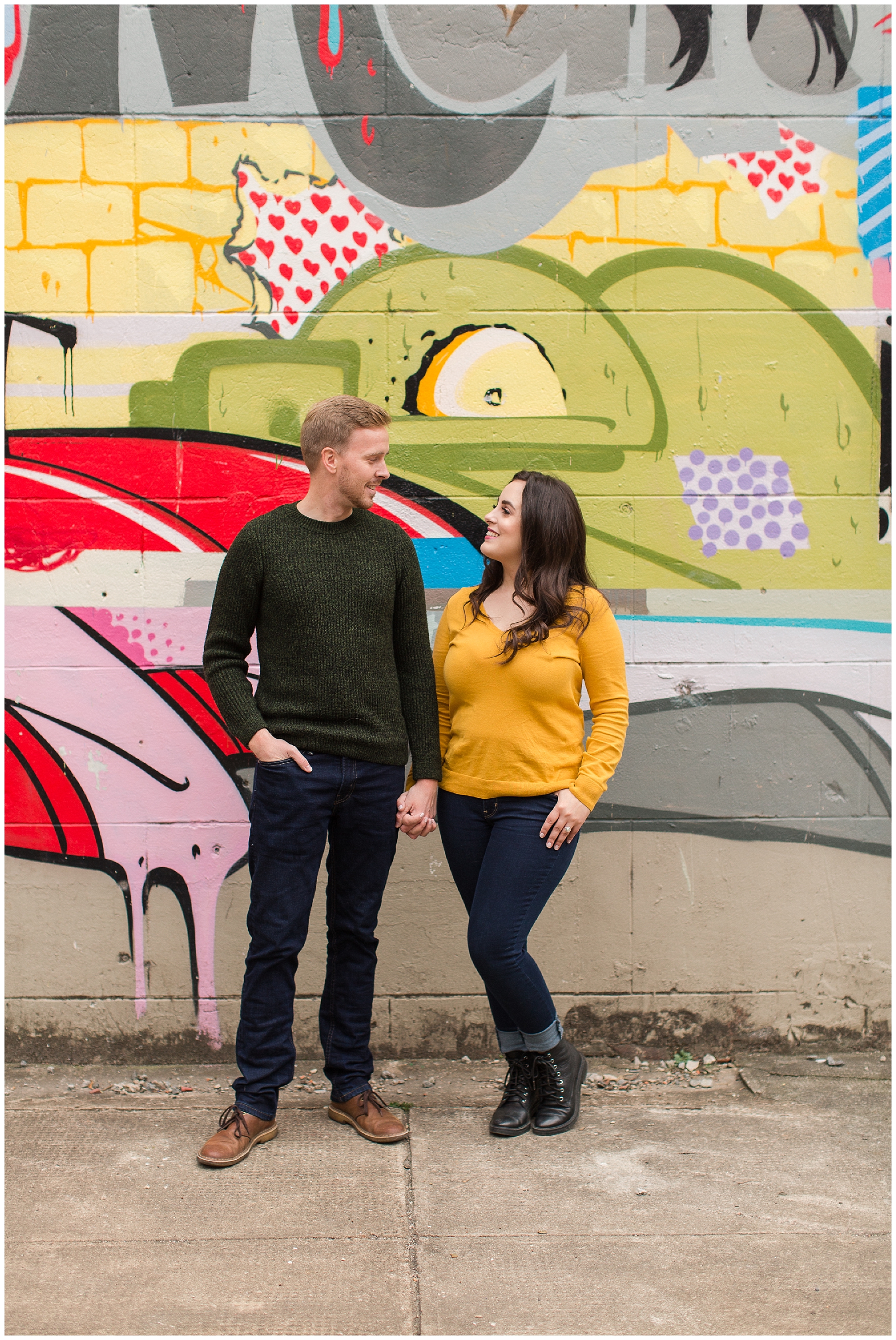 couple posing at canal walk graffiti wall