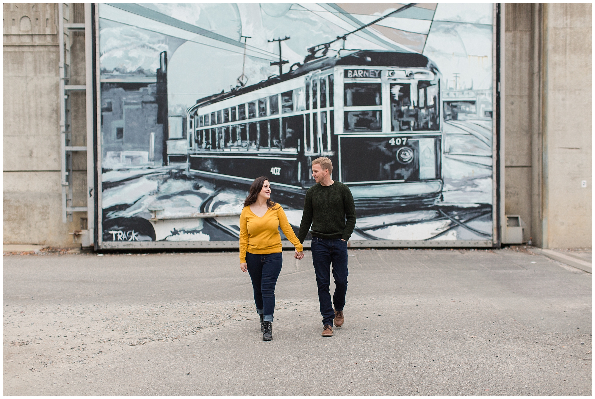 couple posing by train mural Richmond virginia